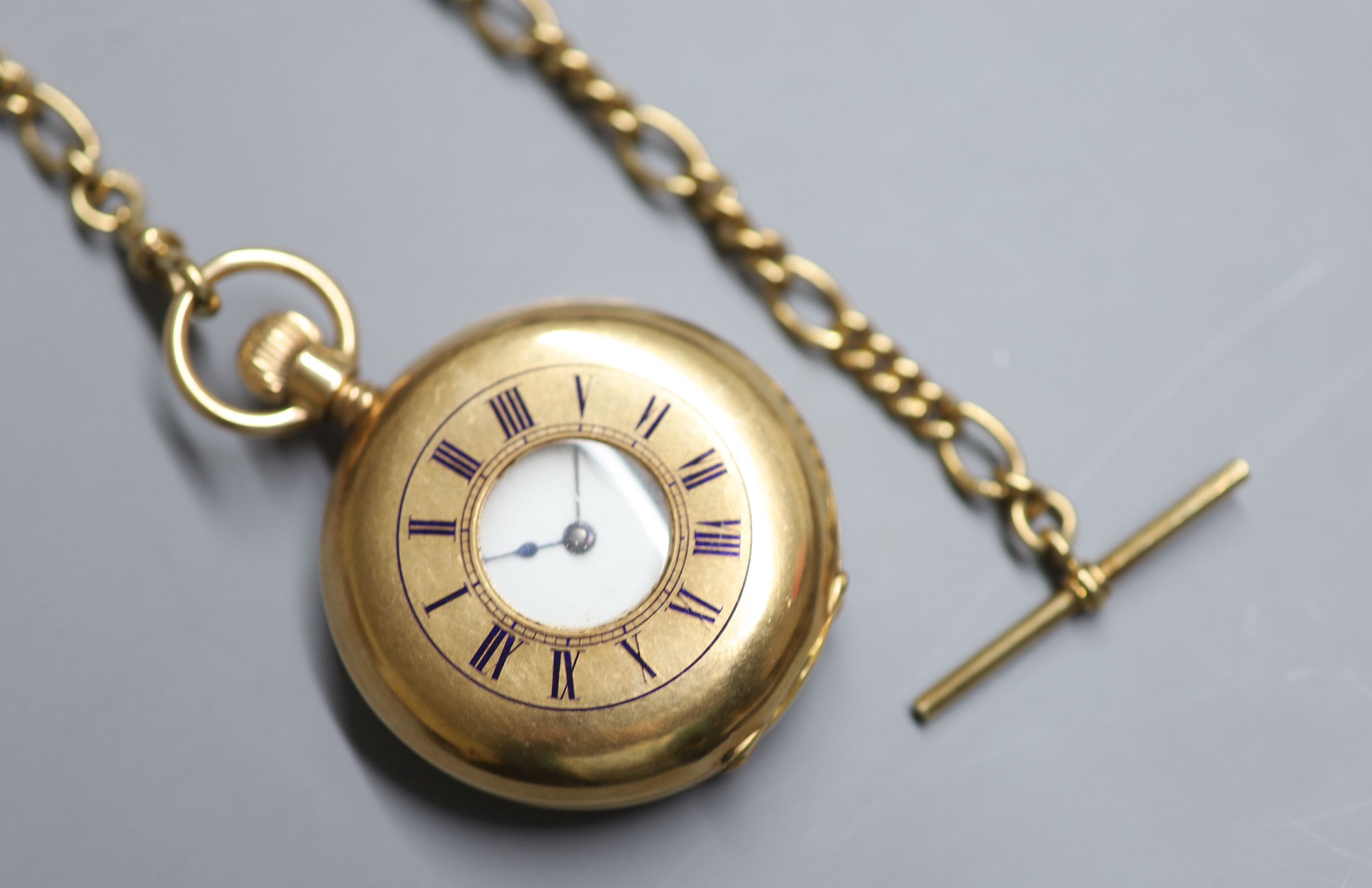 An American Waltham 10ct yellow metal half hunter keyless pocket watch, on a 9ct gold albert,